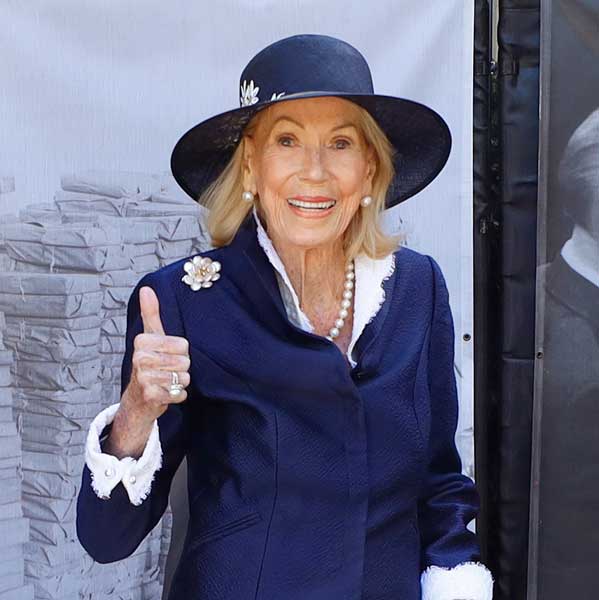 Charlotte Shultz wearing a blue suit and hat