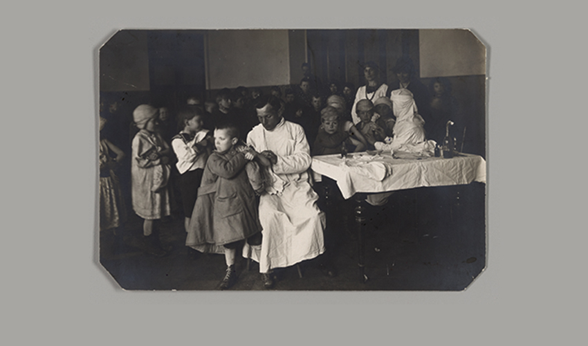 Photograph circa 1922 of a young boy getting vaccinated in Soviet Russia by a doctor