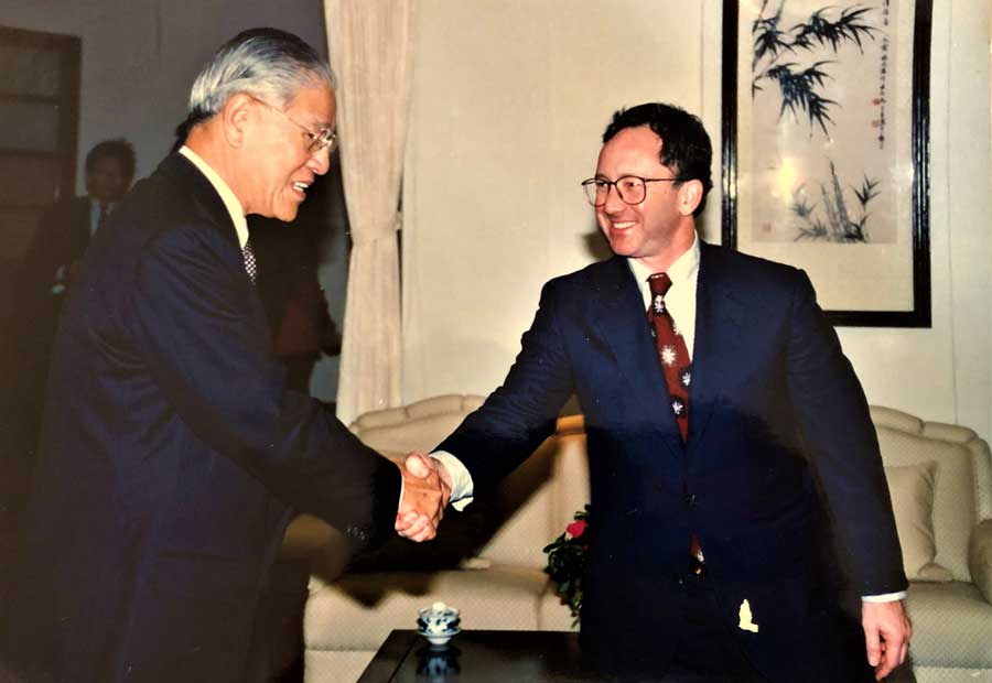 Two men wearing suits shaking hands