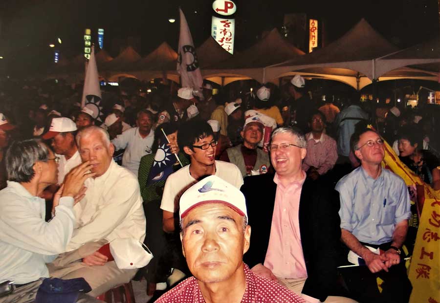 Group of people sitting some holding flags