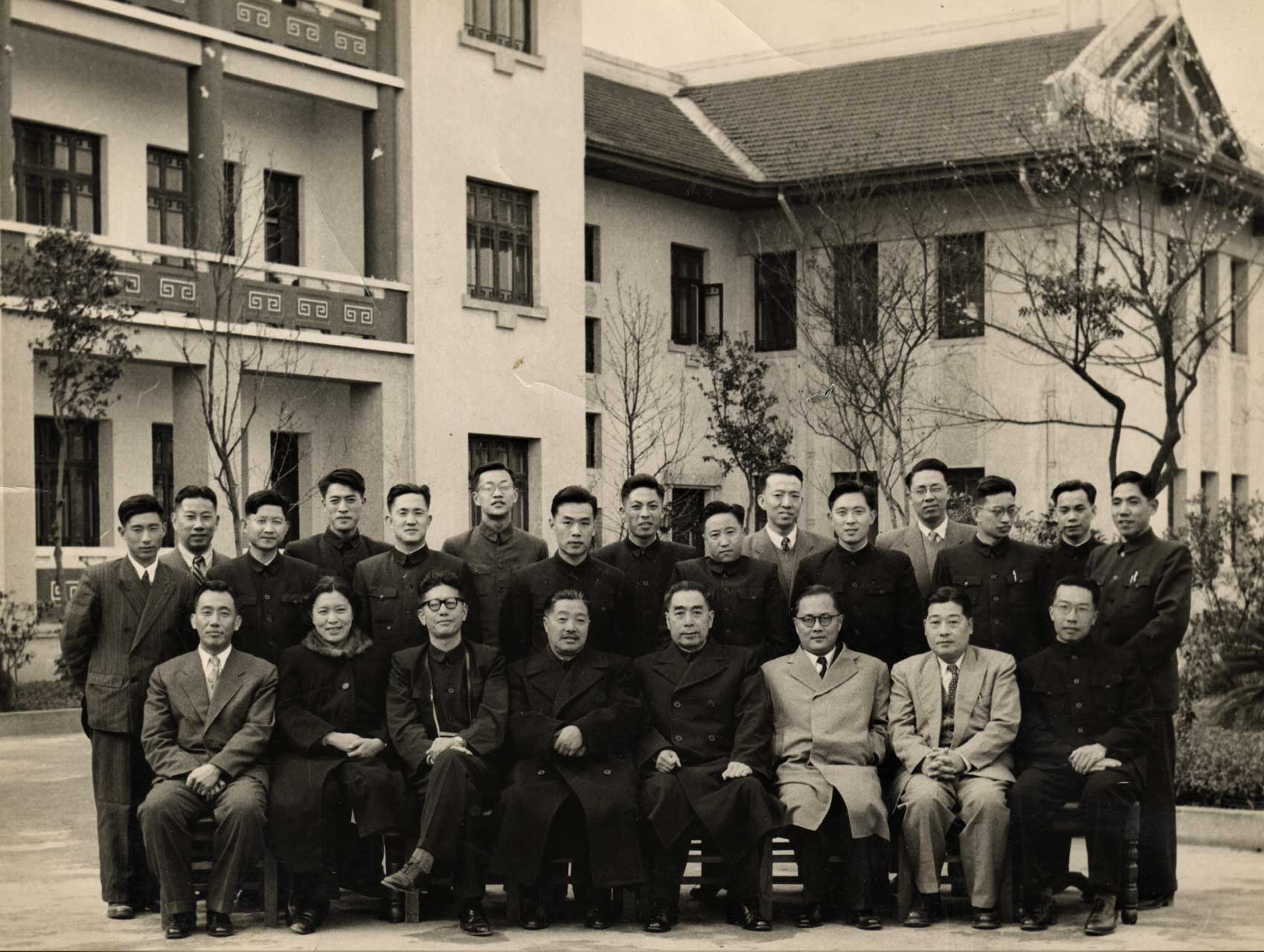 Black and white image of a group in front of buildings