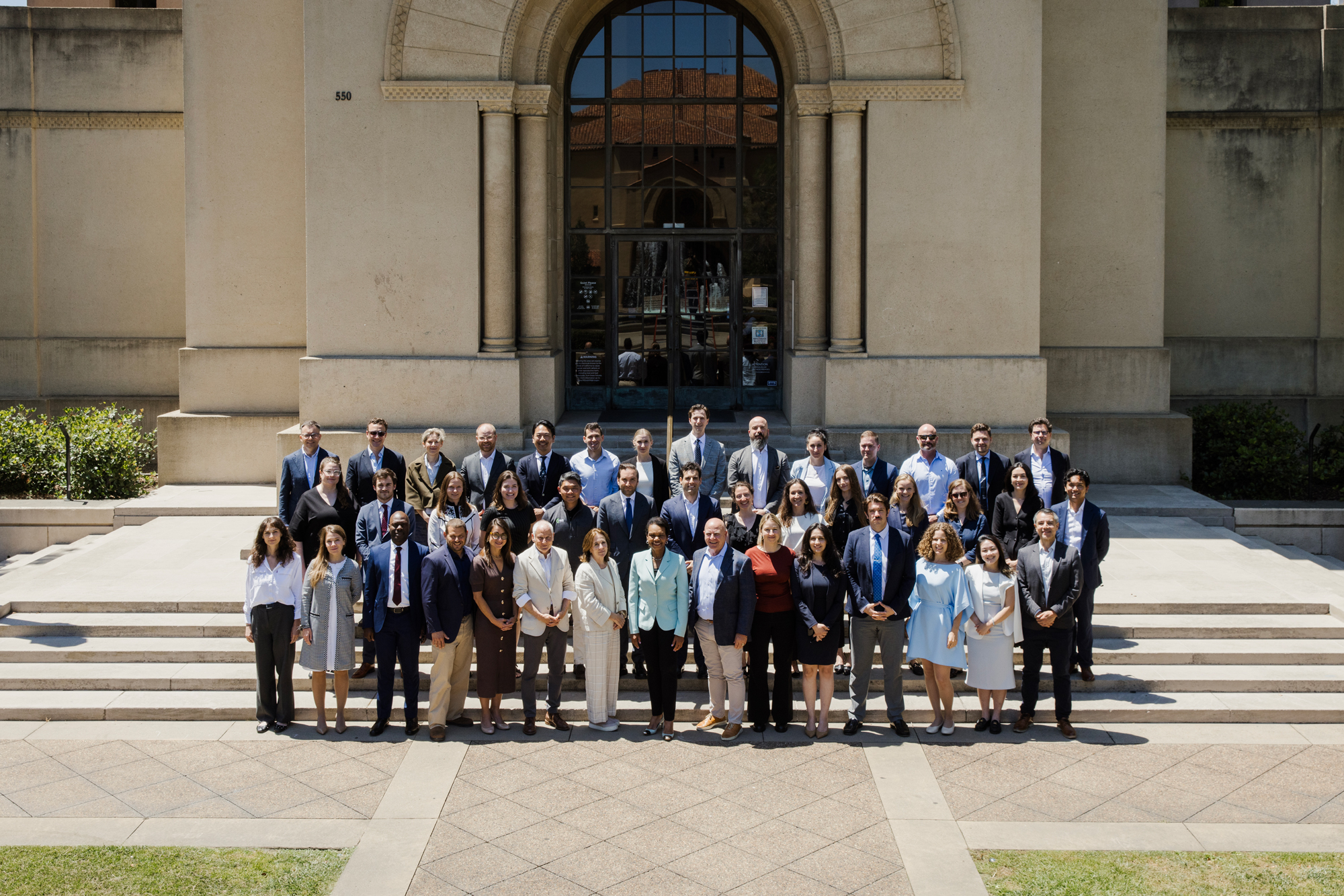 Participants in the 2026 Hoover Institution International Seminar stand with Condoleezza Rice before Hoover Tower on June 23, 2026. (Patrick Beaudouin)