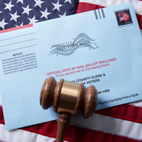 Voting ballot: Absentee voting by mail with ballot envelope on USA flag and gavel stock photo