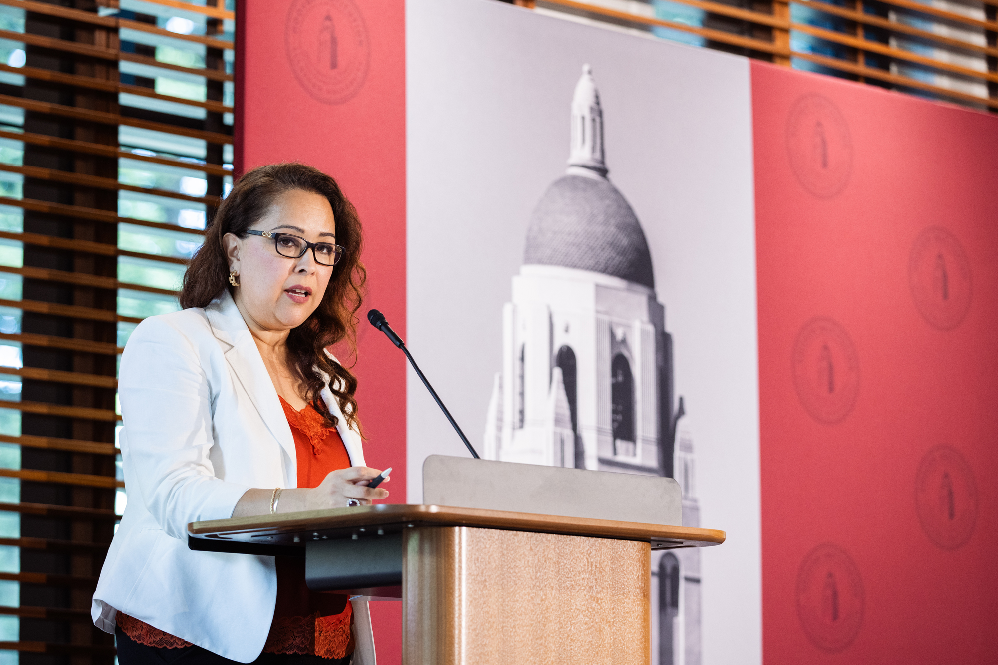 Halima Kazem speaks about her work documenting the experiences of people who fought and endured during the 2001-2021 war in Afghanistan in Hoover’s Shultz Auditorium on April 9, 2026. (Patrick Beaudouin)