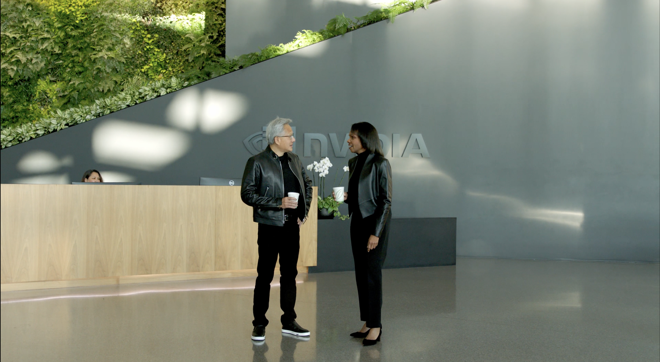 Jensen Huang greets Condoleezza Rice in the lobby of NVIDIA headquarters.