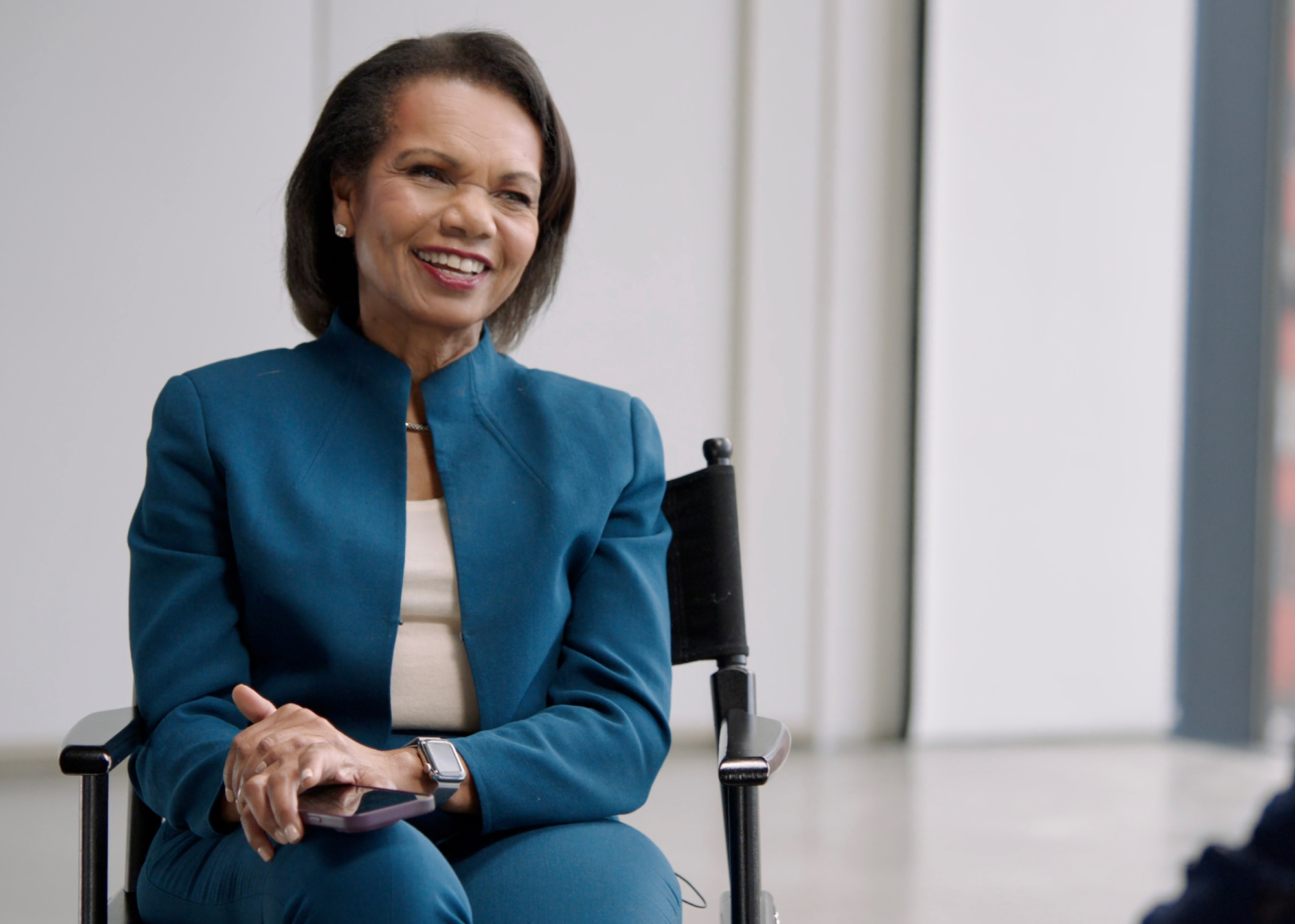 Condoleezza Rice speaking with Indra Nooyi.