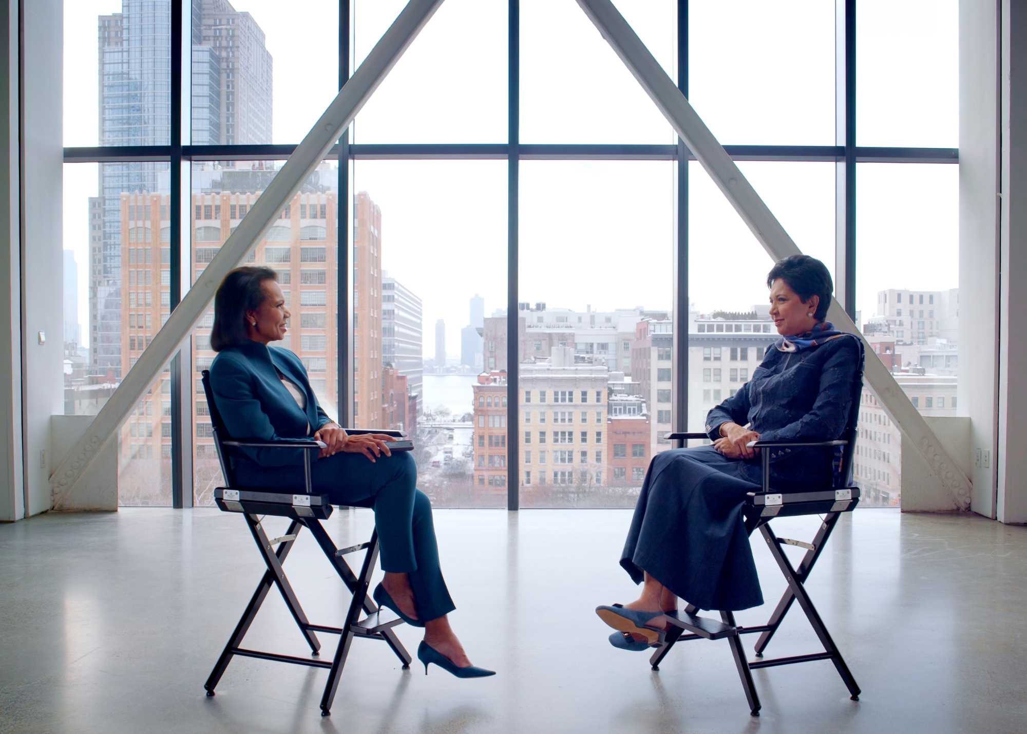 Condoleezza Rice and Indra Nooyi seated on the interview set.