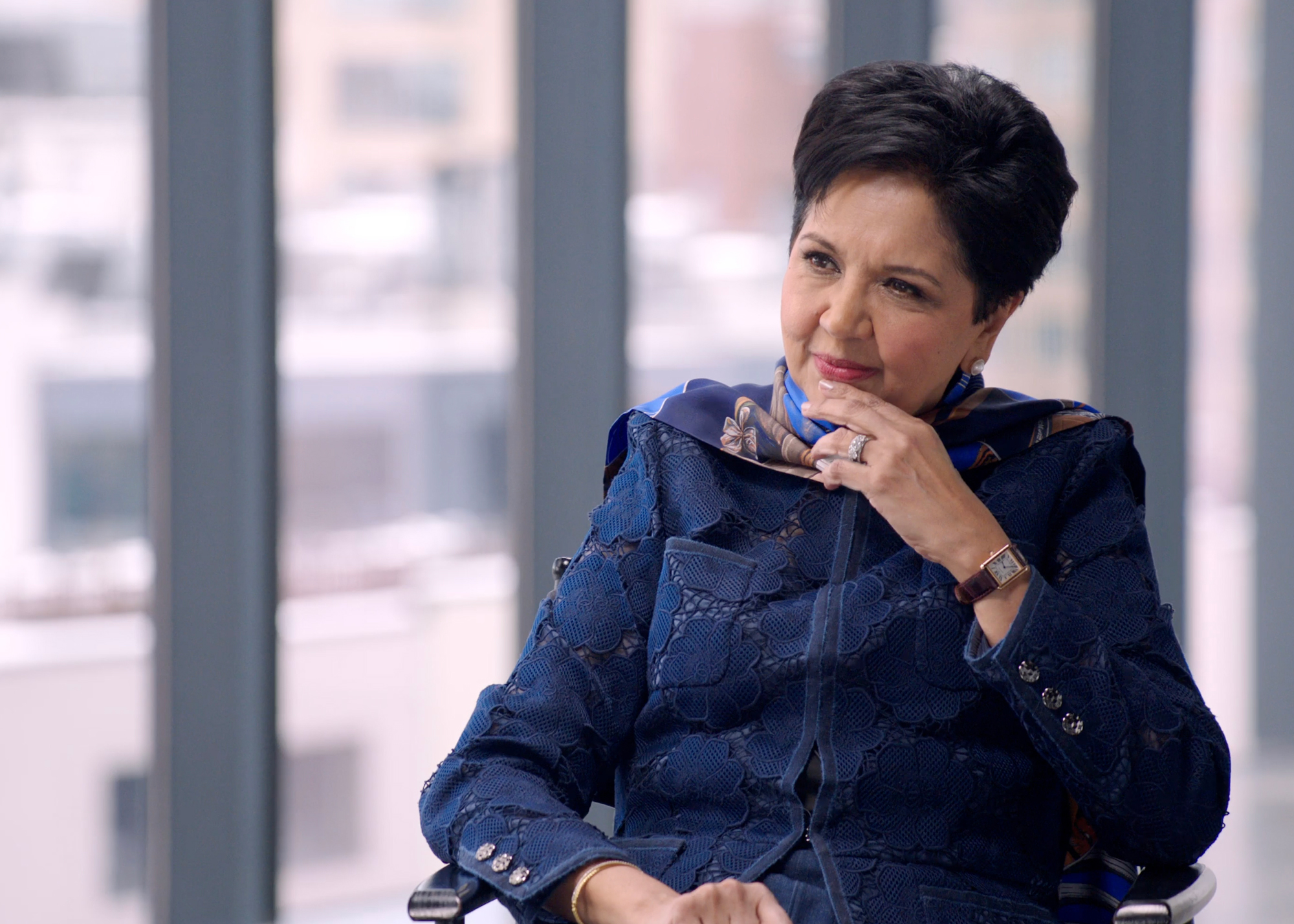 Indra Nooyi listening to Condoleezza Rice during their conversation.