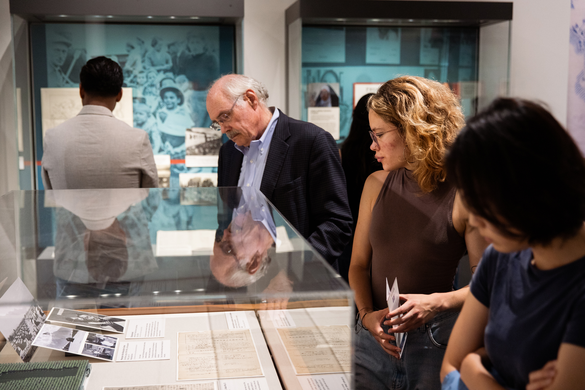 Visitors examine materials from Choosing Freedom: Lives That Defied Tyranny, which features firsthand accounts and artifacts documenting resistance to authoritarian rule.