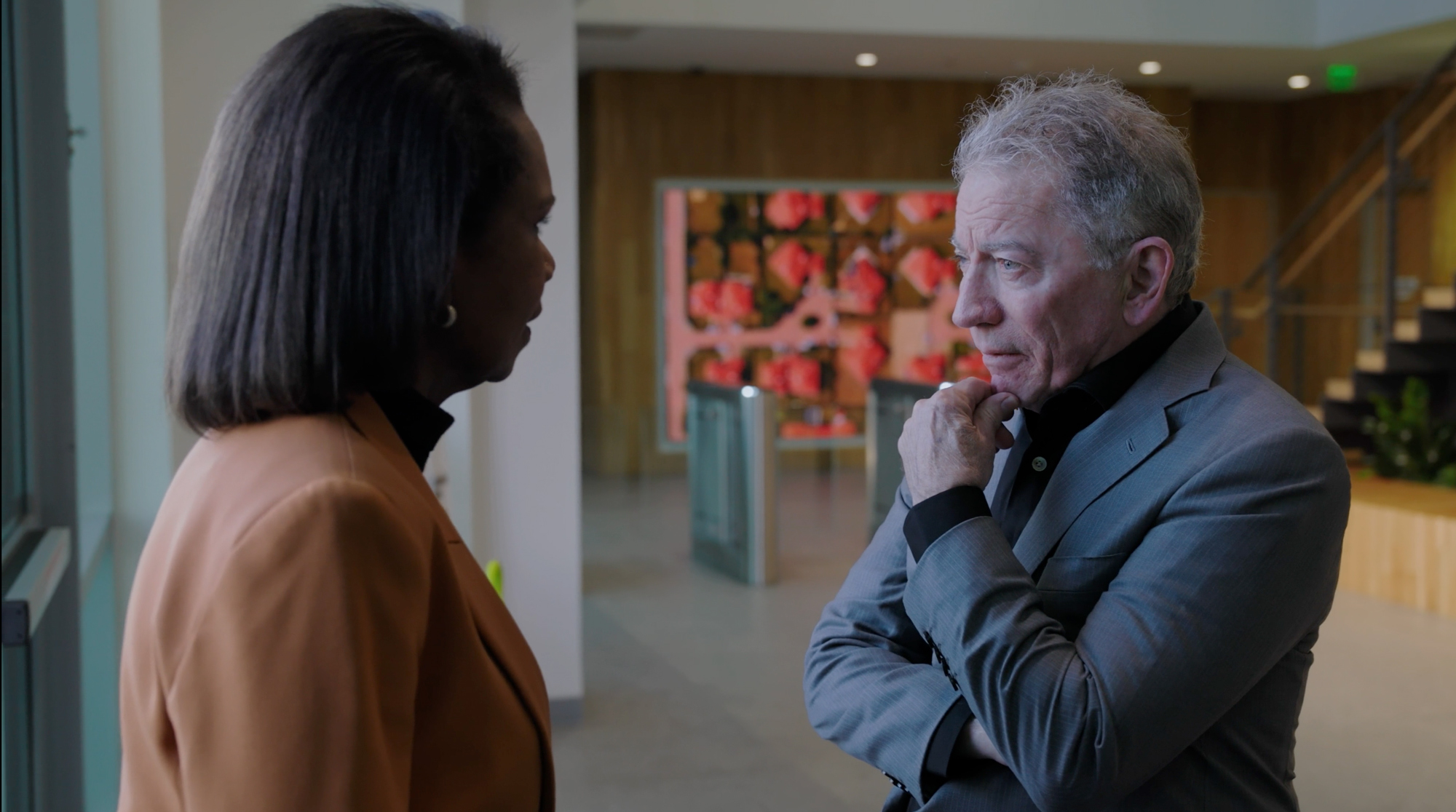 Tom Siebel greets Condoleezza Rice in the lobby of C3 AI.