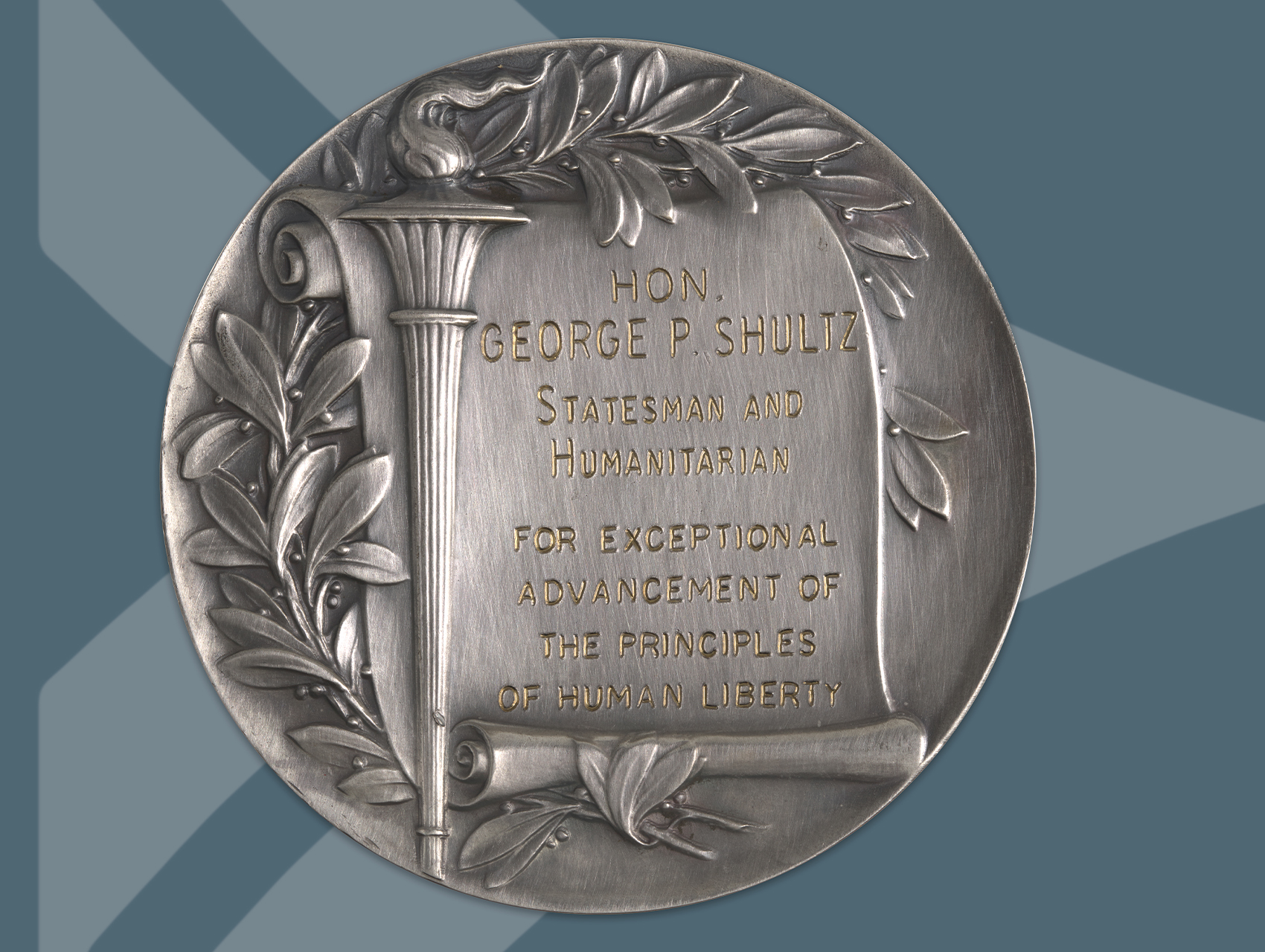 header image showing silver medalion inscribed George P. Shultz Statesman and Humanitarian