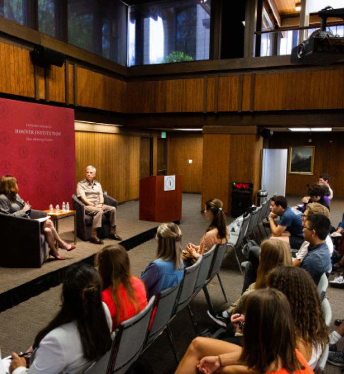 Amy Zegart (left) and General Paul Nakasone in a fireside chat at the Hoover Institution with an audience of Stanford University students.