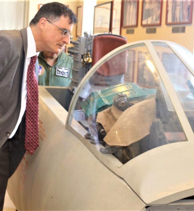 Eric Wakin looking into the cockpit of a plane on display in the American Footprint Museum