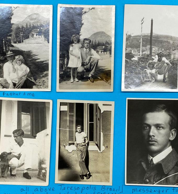 Six black and white photographs adhered to blue paper.