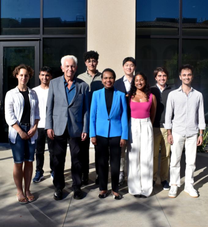 Hoover Institution Director Condoleezza Rice and Senior Fellow Russell A. Berman stand with winners of the Distinguished Undergraduate Essay Competition outside the Shultz Building on October 15, 2024.
