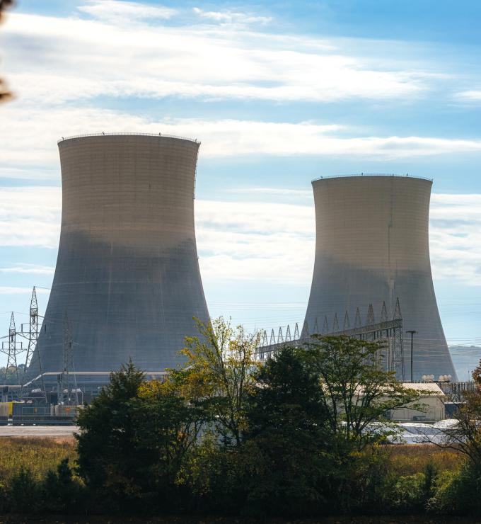 Green Trees surrounding the tall Cooling Towers of a Nuclear Power Plant in Tennessee on a Sunny Autumn Day stock photo