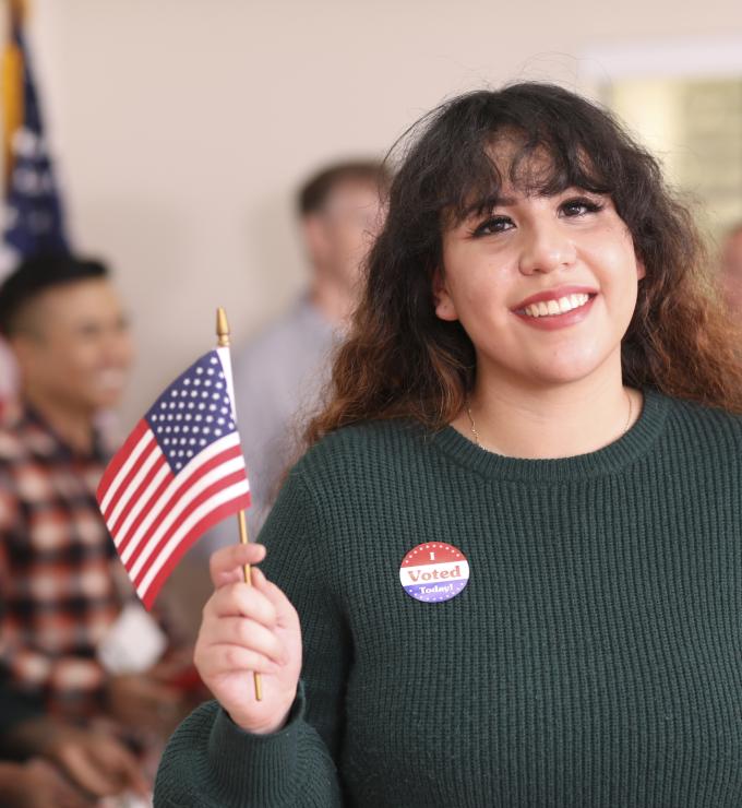 Young adult, Latin descent woman votes in USA election. - stock photo