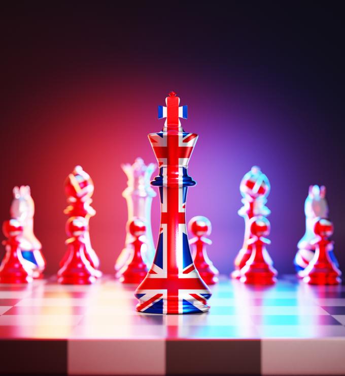 Flag of United Kingdom chess king on a chessboard stock photo