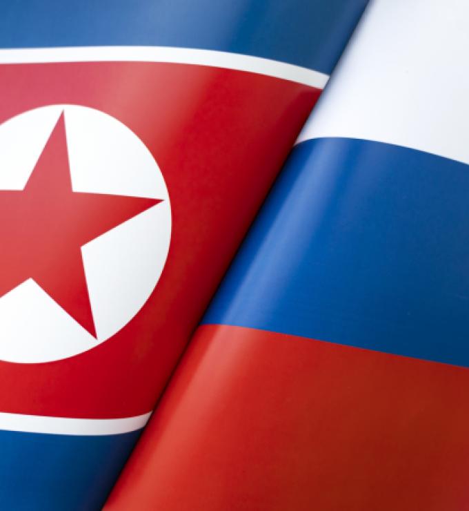 Background of the flags of the North Korea and Russia. The concept of interaction or counteraction between the two countries. International relations. political negotiations. Sports competition. stock photo