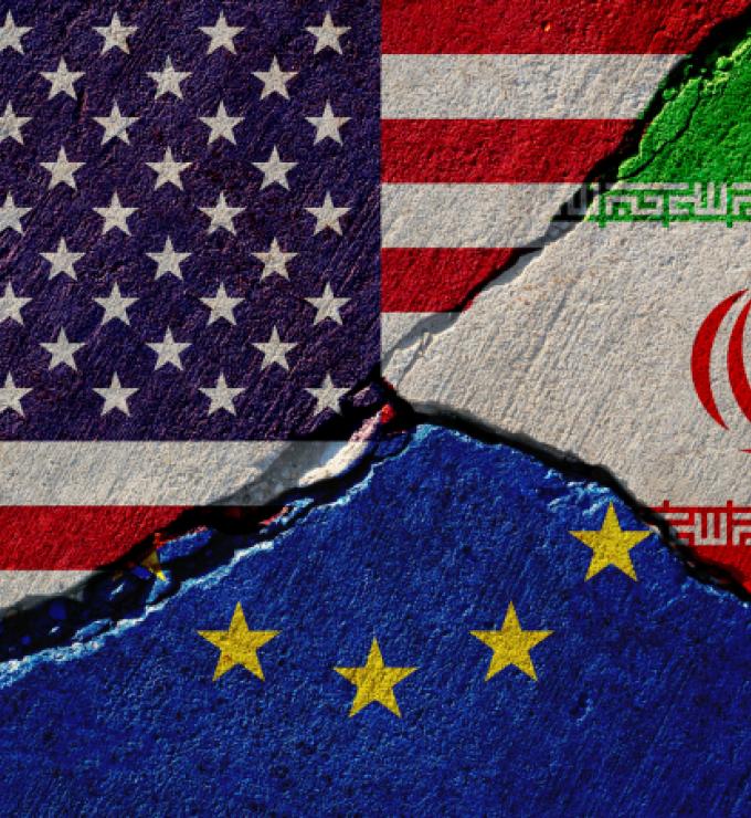 Concrete wall with painted united states, european union and iran flags stock photo