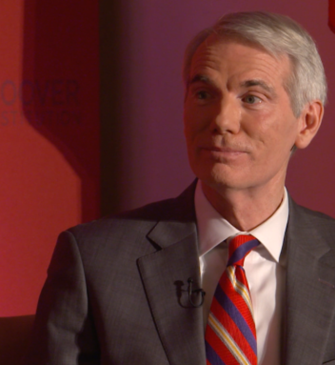 Image of Senator Rob Portman in front an orange-red background