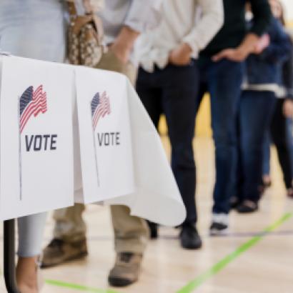 Low angle view of people lined up to vote stock photo