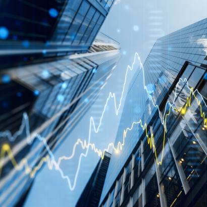 A double exposure image of skyscrapers with overlay of financial graphs, set against a blurred background, illustrating the concept of business growth stock photo