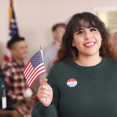 Young adult, Latin descent woman votes in USA election. - stock photo