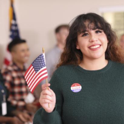 Young adult, Latin descent woman votes in USA election. - stock photo