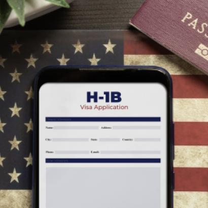 H-1b visa application concept: smartphone with USA H-1B visa application over a USA flag stock photo