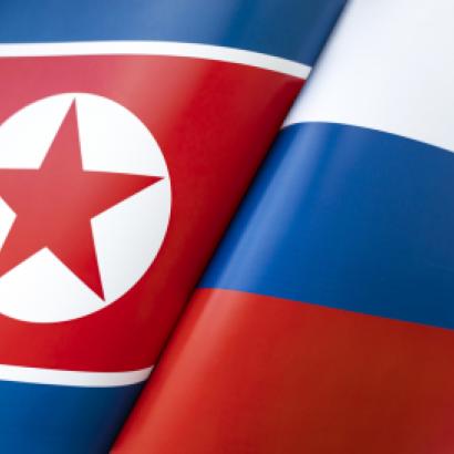 Background of the flags of the North Korea and Russia. The concept of interaction or counteraction between the two countries. International relations. political negotiations. Sports competition. stock photo