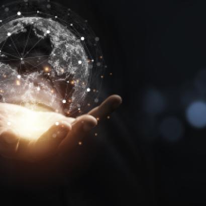 Hand holding virtual world with copy space and blue bokeh background for technology information and transformation concept. stock photo