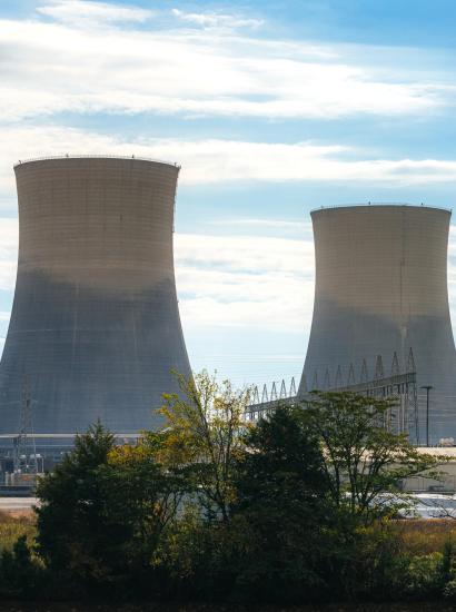 Green Trees surrounding the tall Cooling Towers of a Nuclear Power Plant in Tennessee on a Sunny Autumn Day stock photo