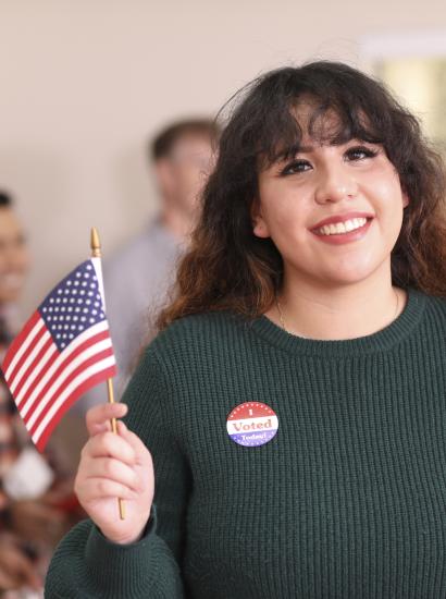 Young adult, Latin descent woman votes in USA election. - stock photo