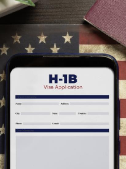 H-1b visa application concept: smartphone with USA H-1B visa application over a USA flag stock photo
