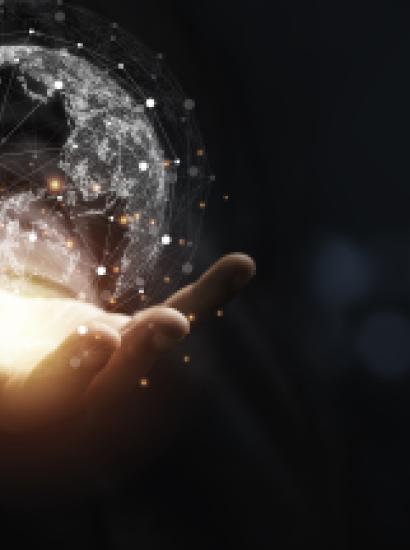 Hand holding virtual world with copy space and blue bokeh background for technology information and transformation concept. stock photo
