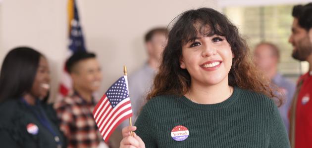 Young adult, Latin descent woman votes in USA election. - stock photo