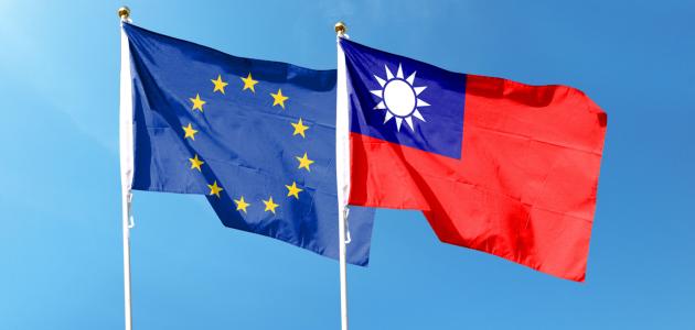 European Union flag and Taiwan flag on cloudy sky. waving in the sky stock photo