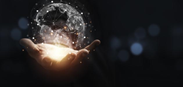 Hand holding virtual world with copy space and blue bokeh background for technology information and transformation concept. stock photo