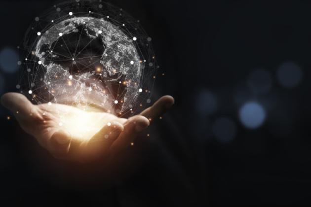 Hand holding virtual world with copy space and blue bokeh background for technology information and transformation concept. stock photo