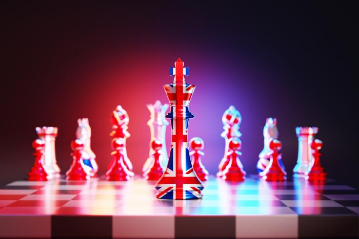 Flag of United Kingdom chess king on a chessboard stock photo