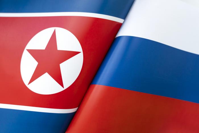 Background of the flags of the North Korea and Russia. The concept of interaction or counteraction between the two countries. International relations. political negotiations. Sports competition. stock photo