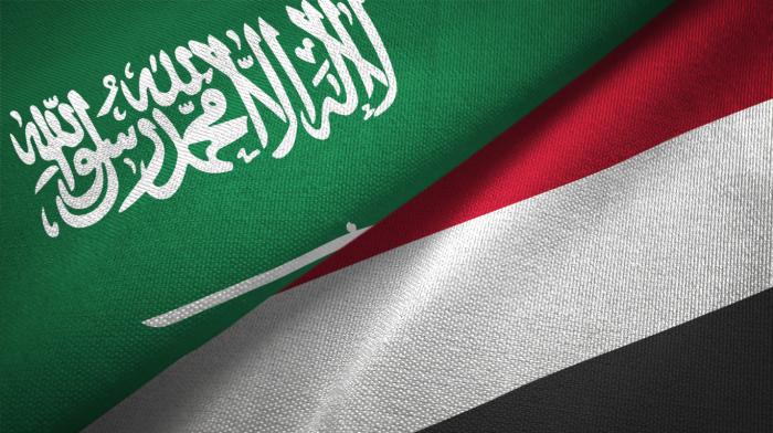 Yemen and Saudi Arabia two flags together textile cloth, fabric texture stock photo