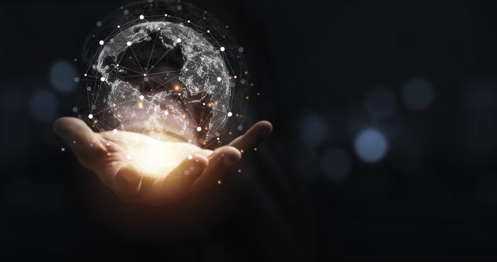 Hand holding virtual world with copy space and blue bokeh background for technology information and transformation concept. stock photo