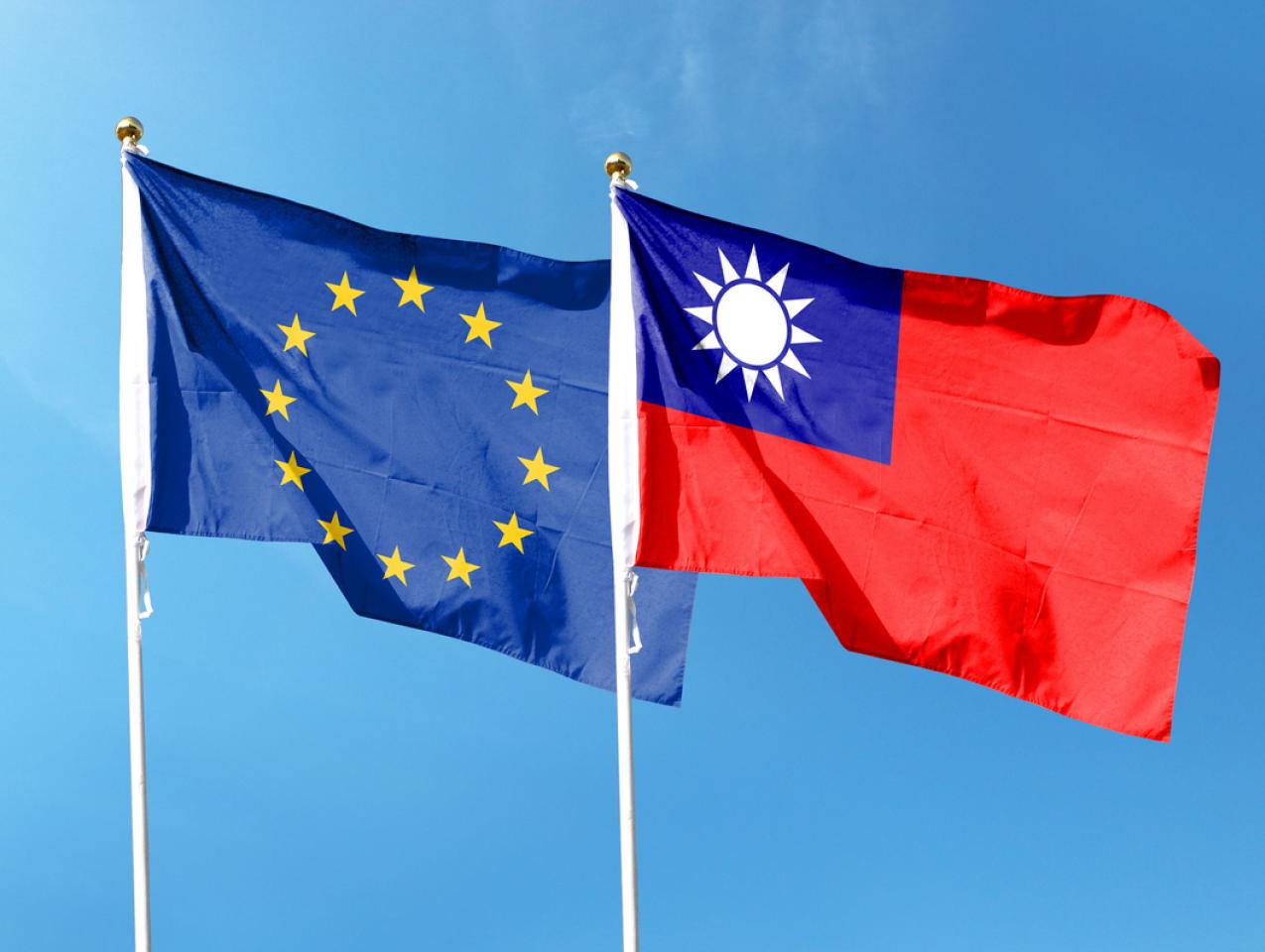 European Union flag and Taiwan flag on cloudy sky. waving in the sky stock photo