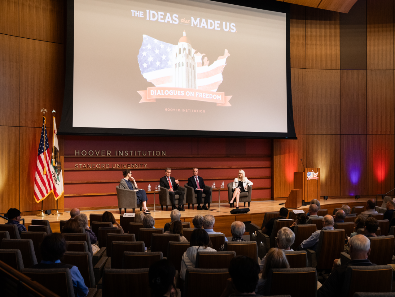 (From left to right) Washington Post columnist Megan McArdle and senior fellows John Cochrane, Ross Levine and Valerie Ramey speak about America’s future economic prospects in Hauck Auditorium on May 12, 2026. (Patrick Beaudouin)