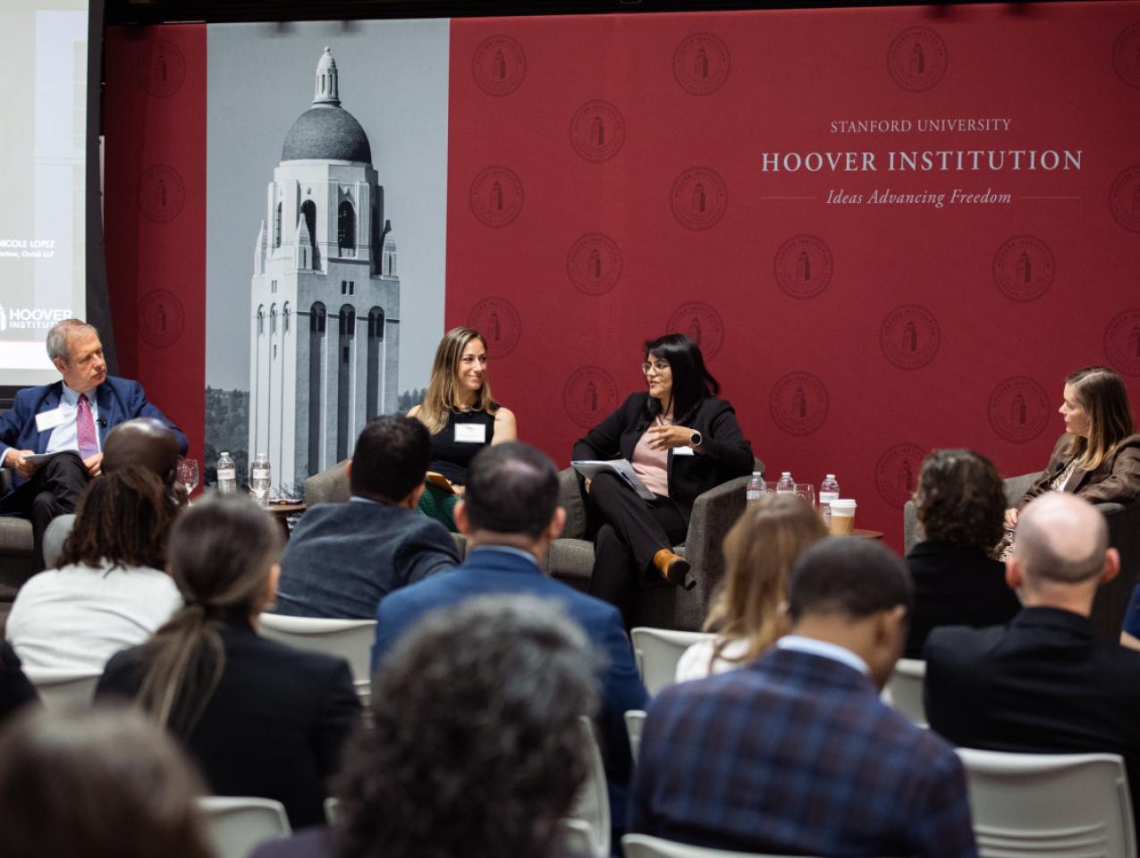 Senior Fellow Eugene Volokh (right), Katie Visser of Cloudflare, Ellie Sakahee of Google and Nicole Lopez of Orrick LLP are seen in Hoover’s Stauffer Auditorium on July 21, 2026.