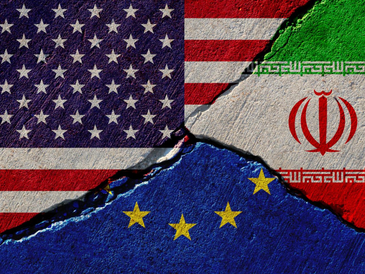 Concrete wall with painted united states, european union and iran flags stock photo