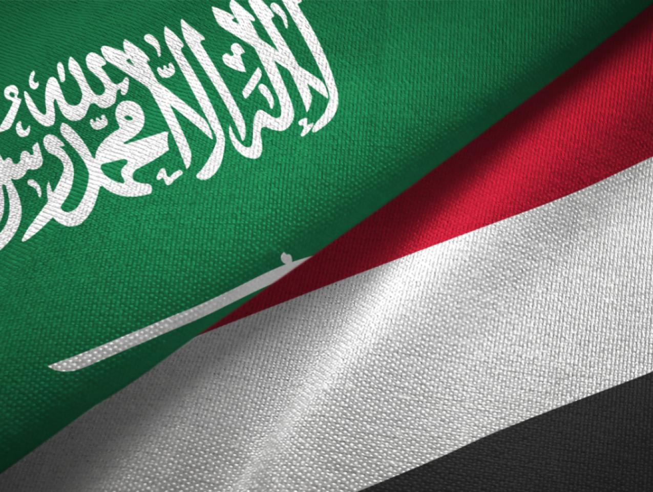 Yemen and Saudi Arabia two flags together textile cloth, fabric texture stock photo