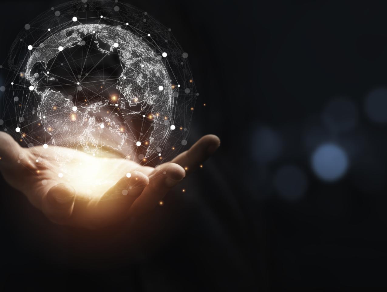 Hand holding virtual world with copy space and blue bokeh background for technology information and transformation concept. stock photo